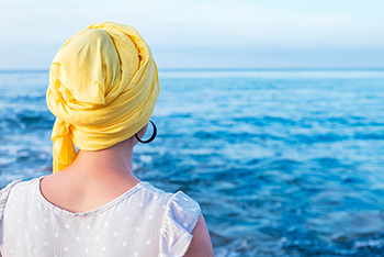 picture of a woman looking towards the blue ocean